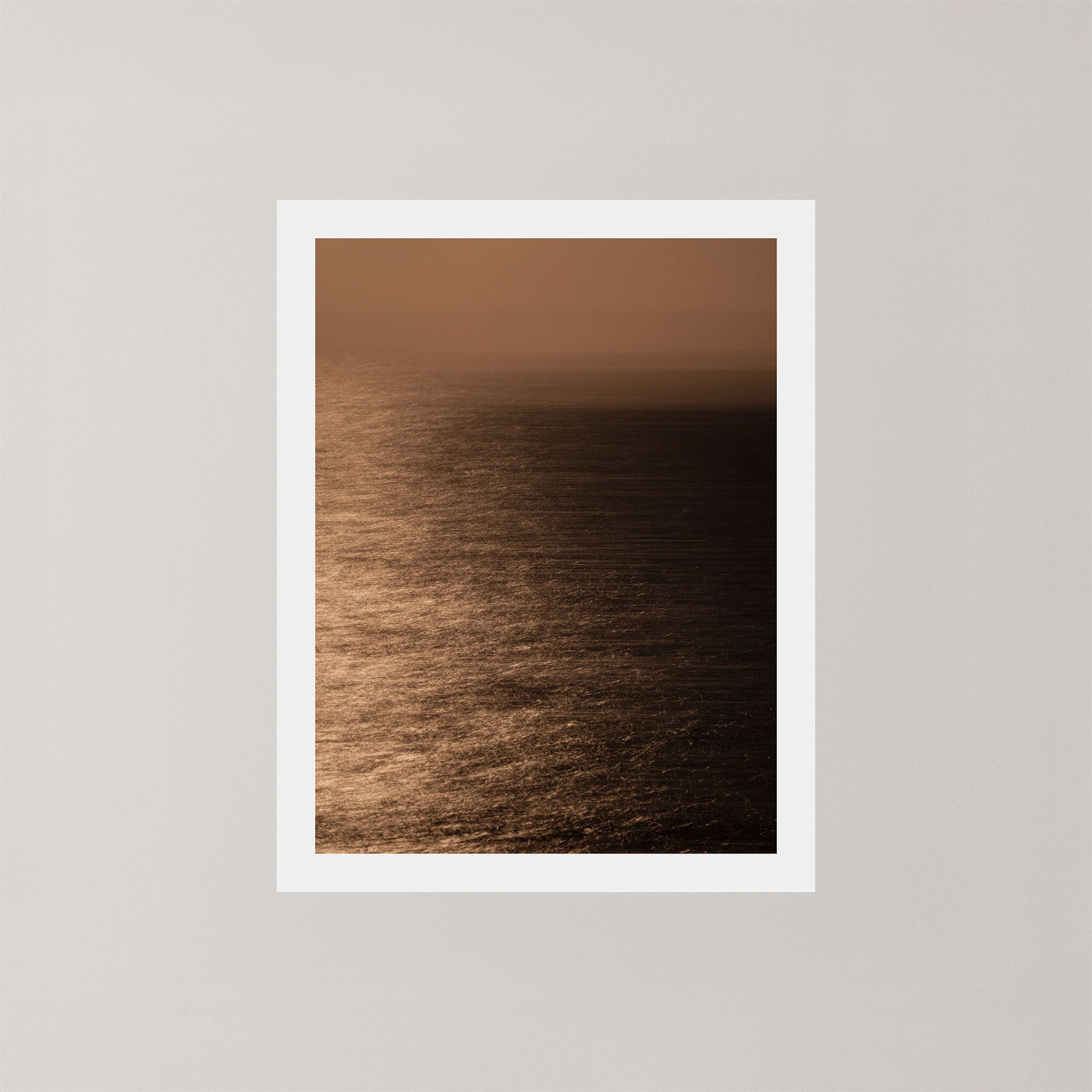 Photography art print of the Sydney ocean illuminated by moonlight, with rich golden and dark tones.