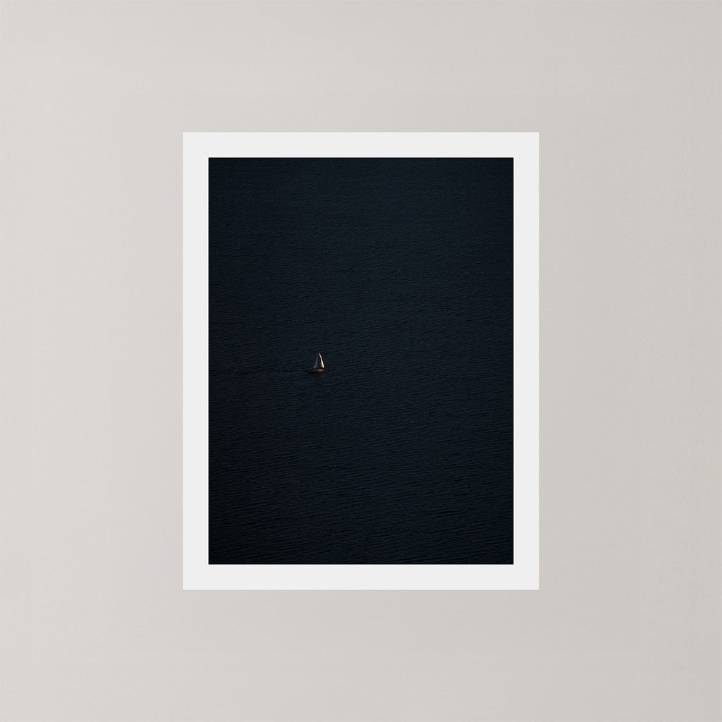 Voyage unframed art print featuring a single sailing boat on the ocean.